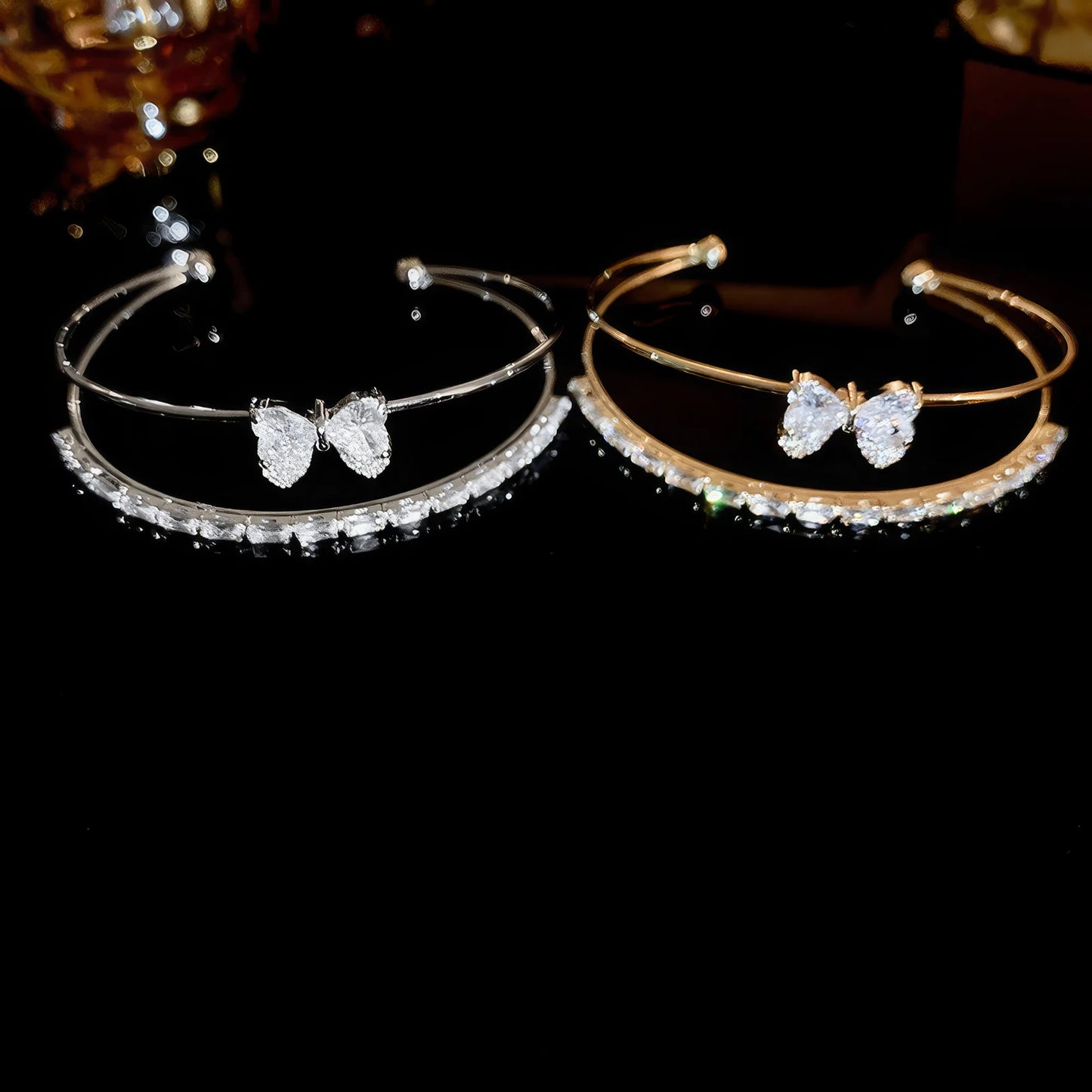 Pair of bowknot heart bracelets isolated on a black background.