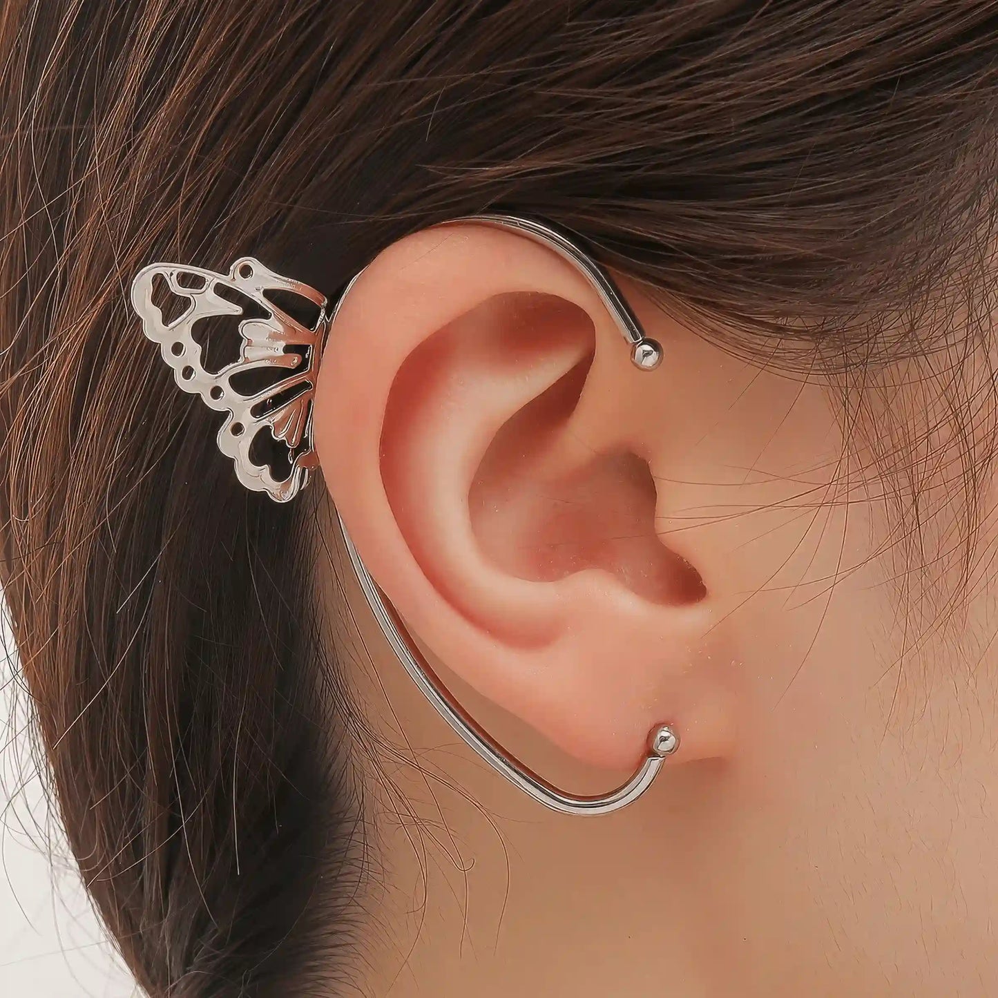 Butterfly - style ear cuff worn on ear, showcasing the detailed butterfly wings.