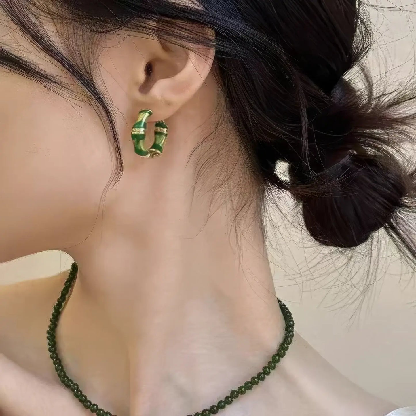 Chinese - style bamboo knot enamel earring worn, paired with a green necklace, showcasing the harmonious Chinese - style accessory combination.