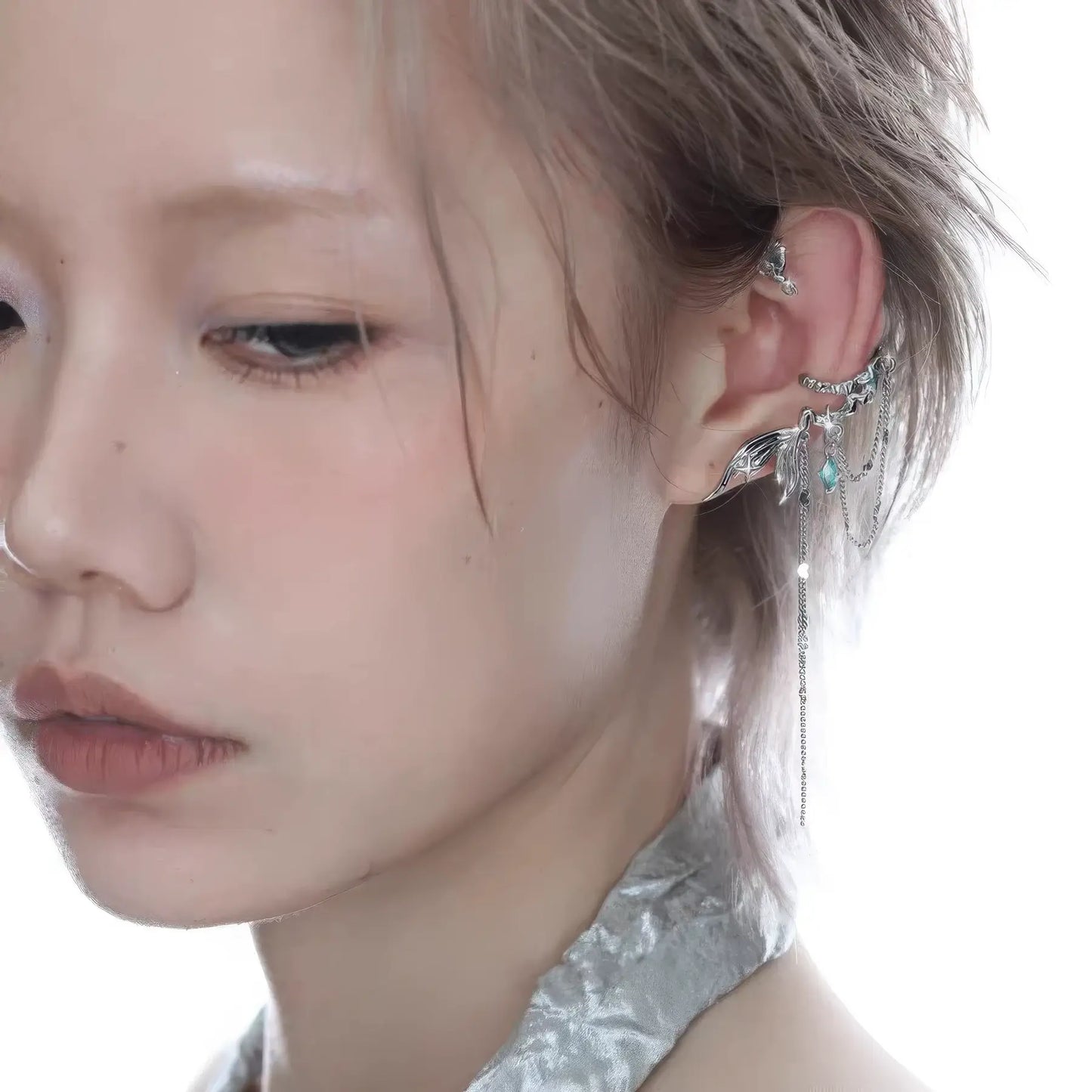 Cool fish tail tassel ear cuff worn on ear, showcasing the delicate fish tail and tassel design.