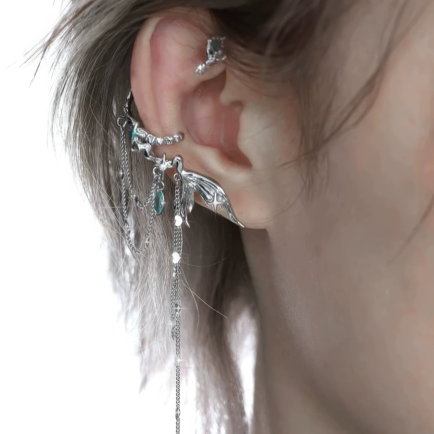 Cool fish tail tassel ear cuff worn on ear, with close - up view of the intricate design.