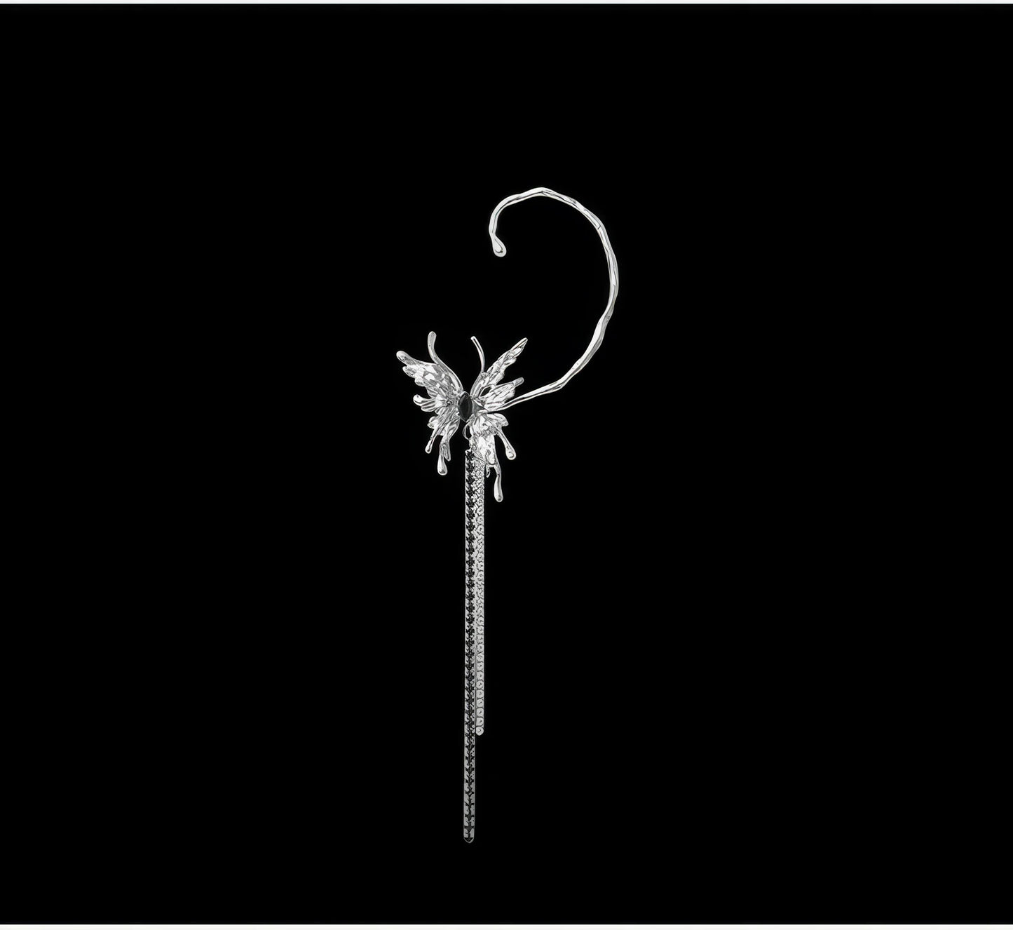 Liquid metal butterfly tassel ear cuff isolated on black background.