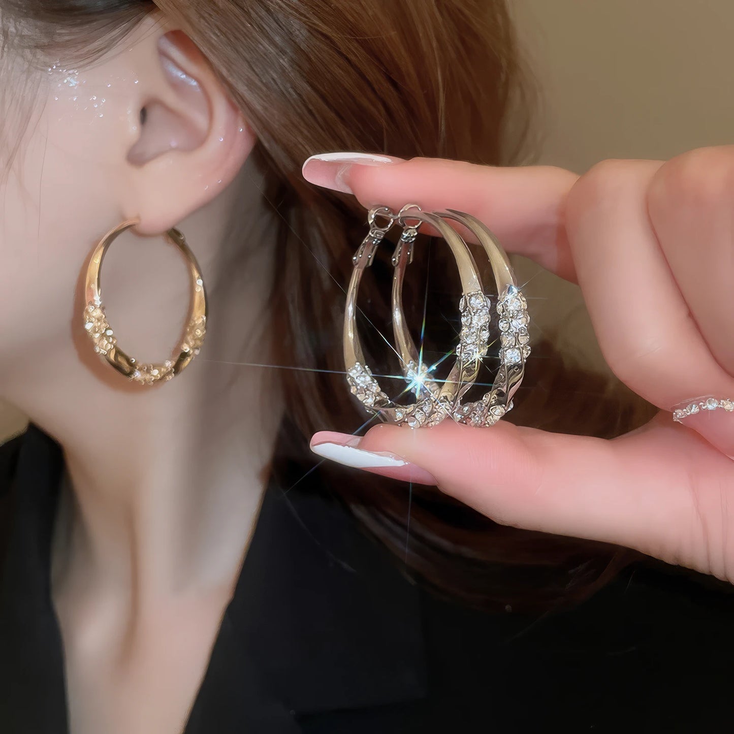 Gold and silver twisted diamond - inlaid hoop earrings, hand - held and worn, highlighting the stacked, sparkling look