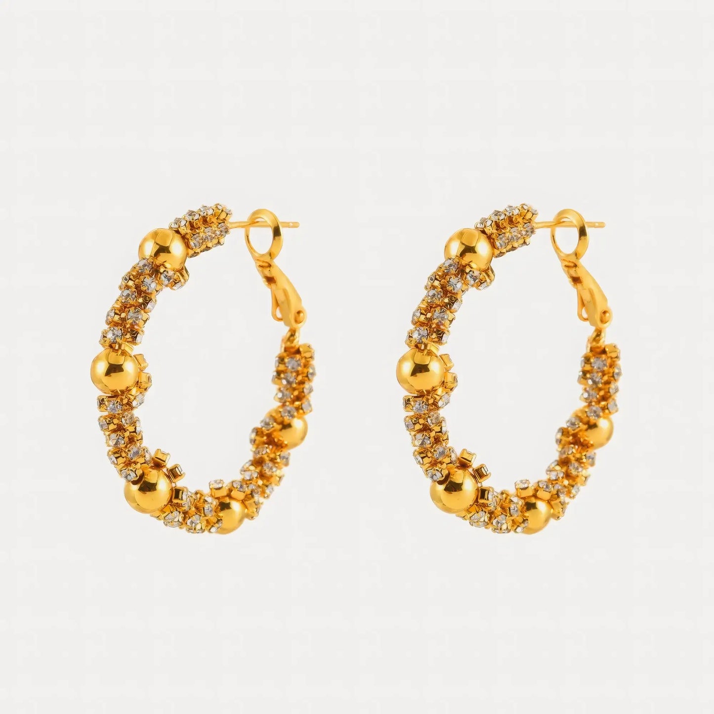 Pair of gold zircon - wrapped beaded hoop earrings, showcasing the intricate bead and zircon arrangement
