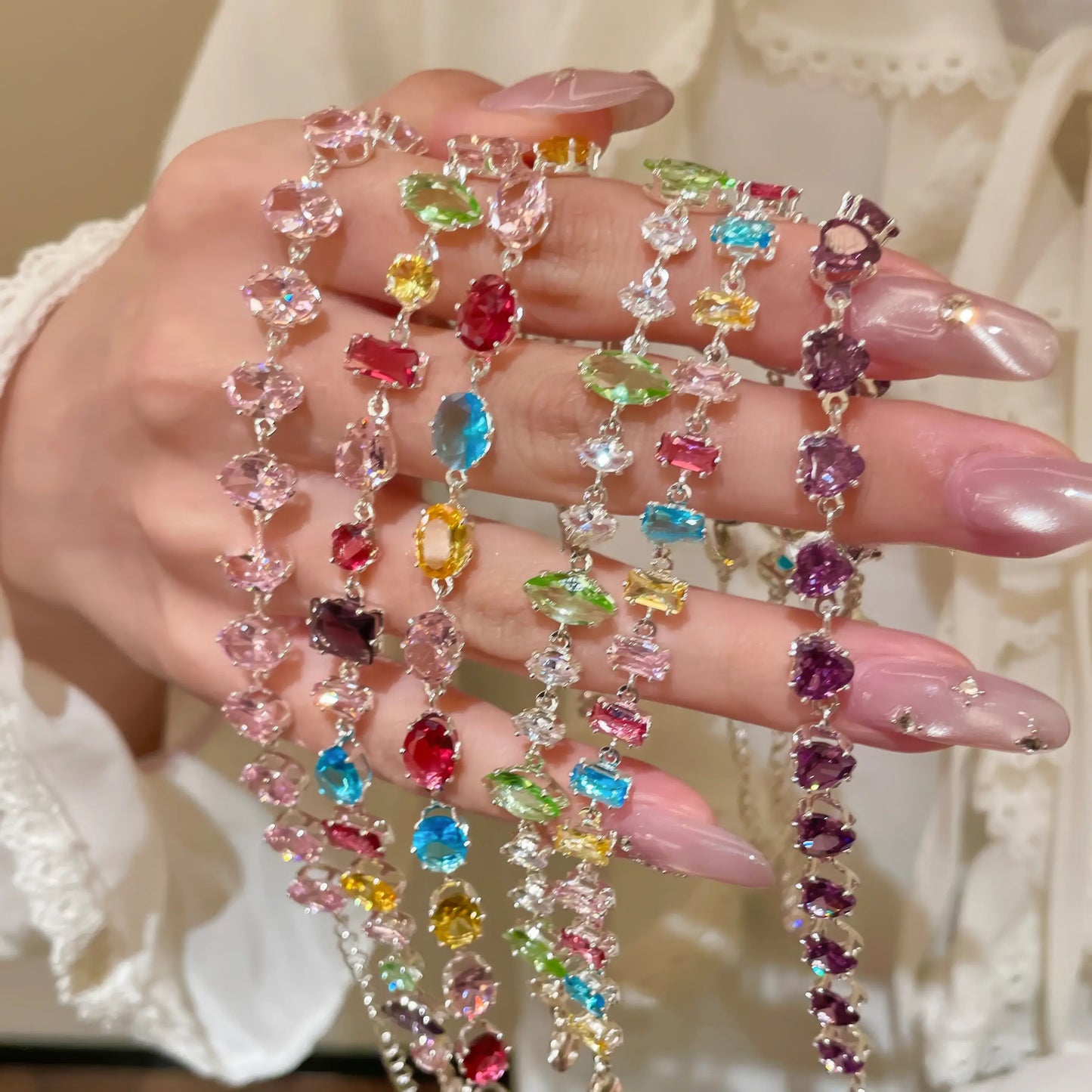 Zircon colorful oval bracelet held in hand, showcasing colorful oval details.