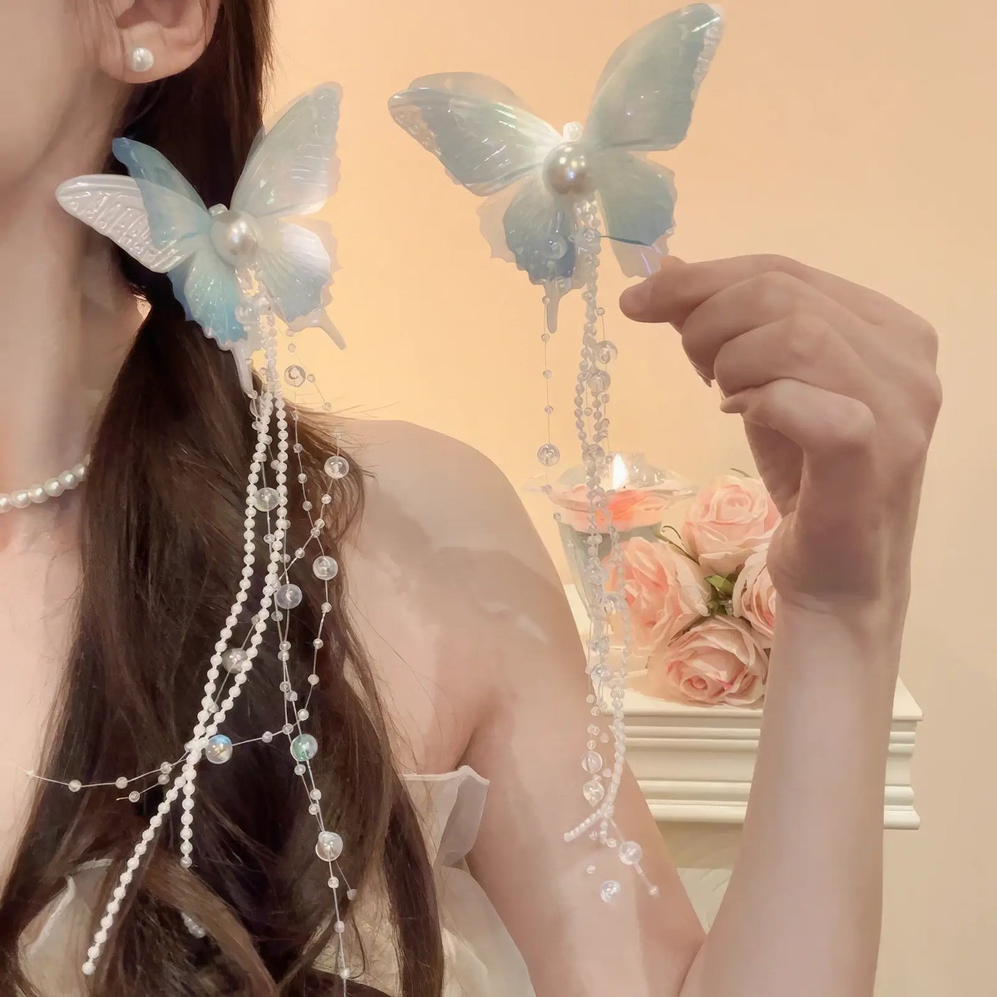 Blue and green butterfly bow pearl tassel hair clips worn on a ponytail hairstyle