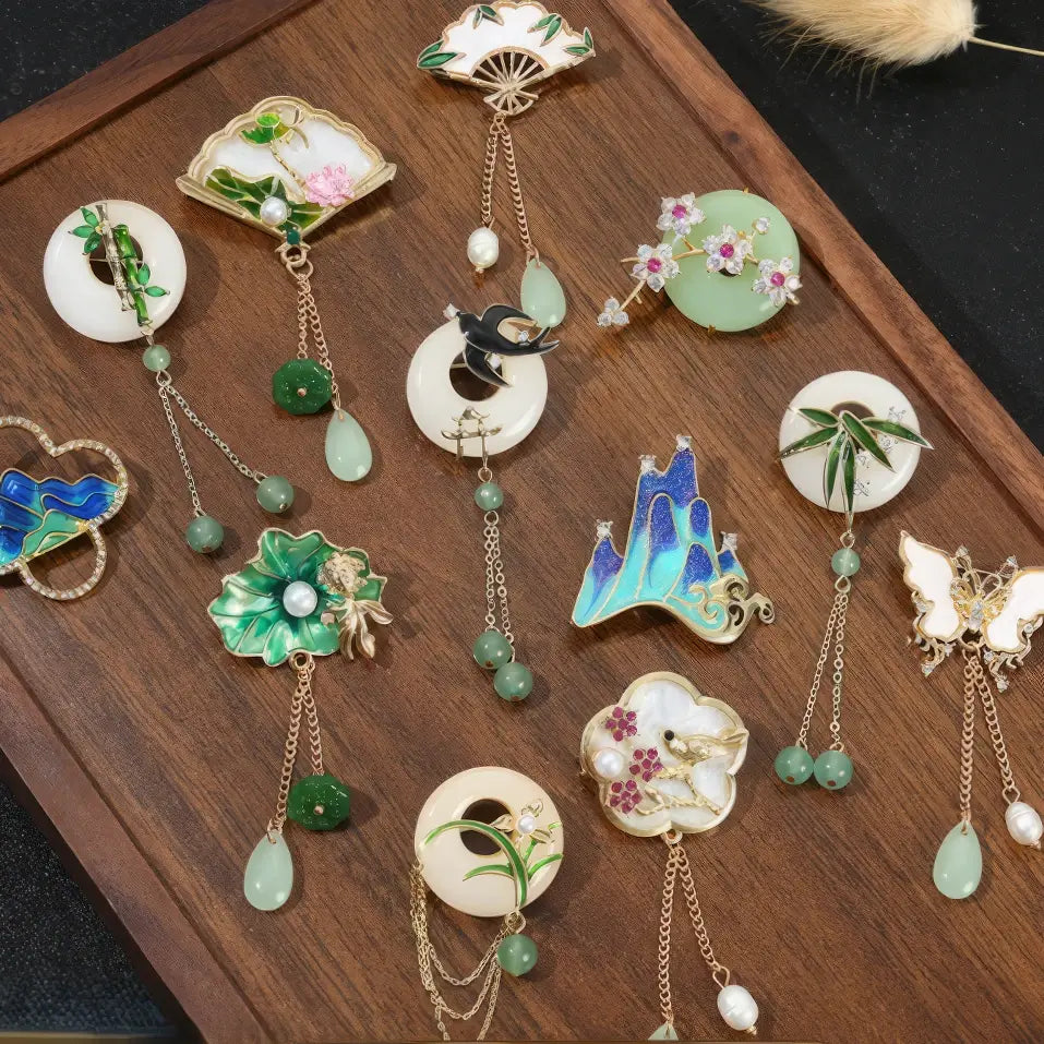 Set of Chinese - style premium brooches with various designs, on wooden background