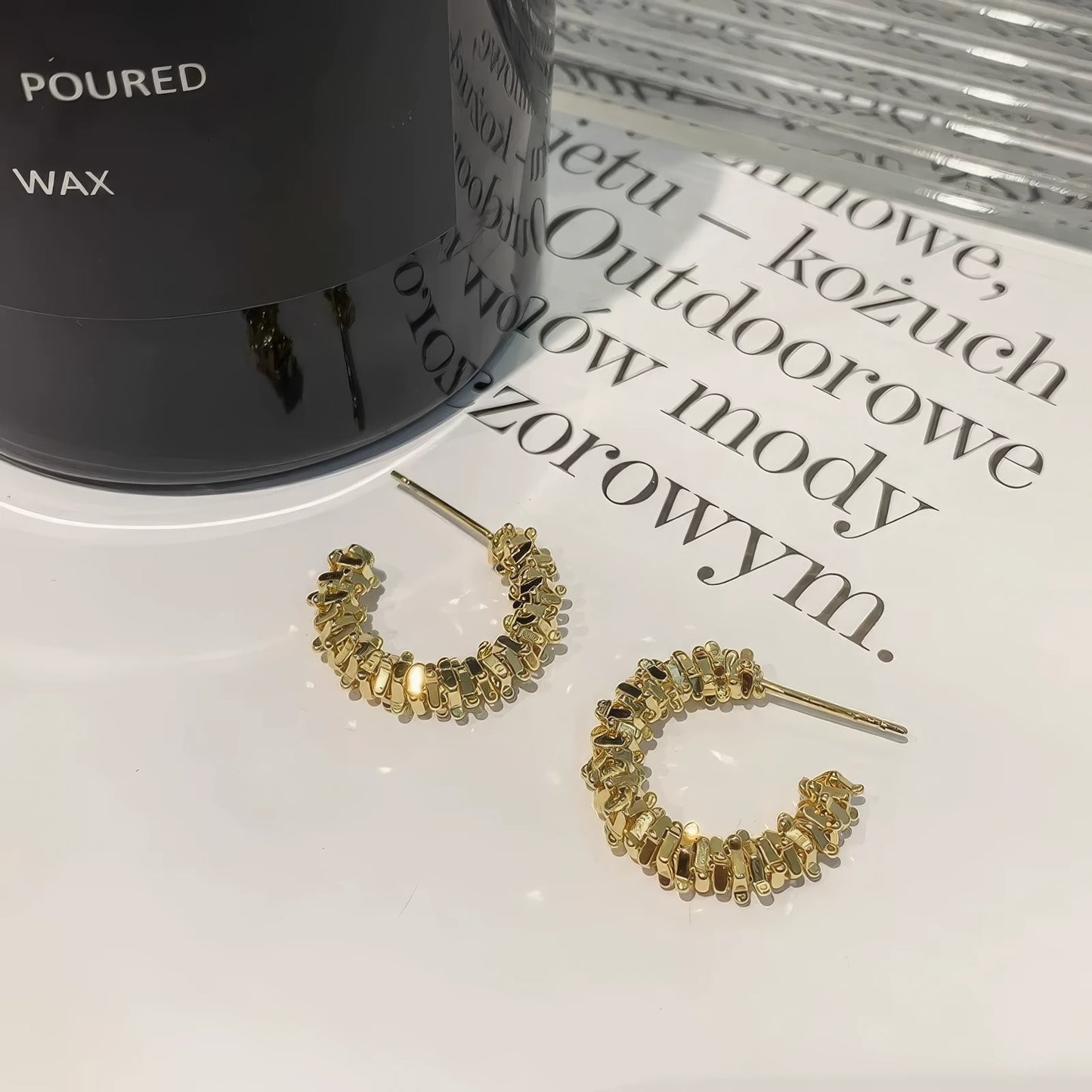 Gold circle broken silver earrings, isolated on surface with text