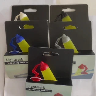 Multiple desk lamp - shaped bookmarks in colorful packages, displayed on table