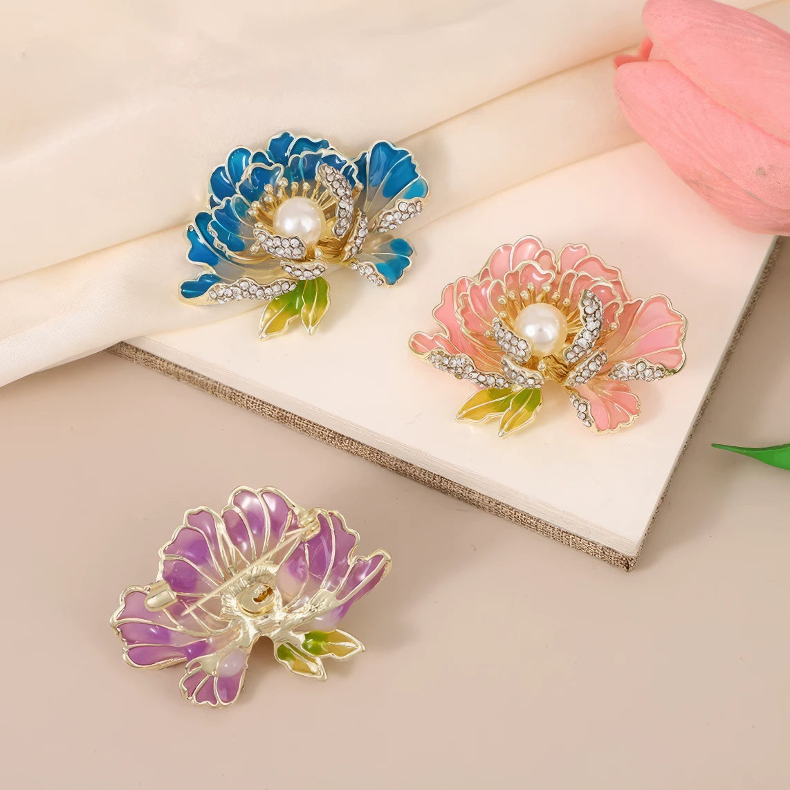 Multiple First Bloom Brocade brooches, blue, pink, purple flowers, on white card