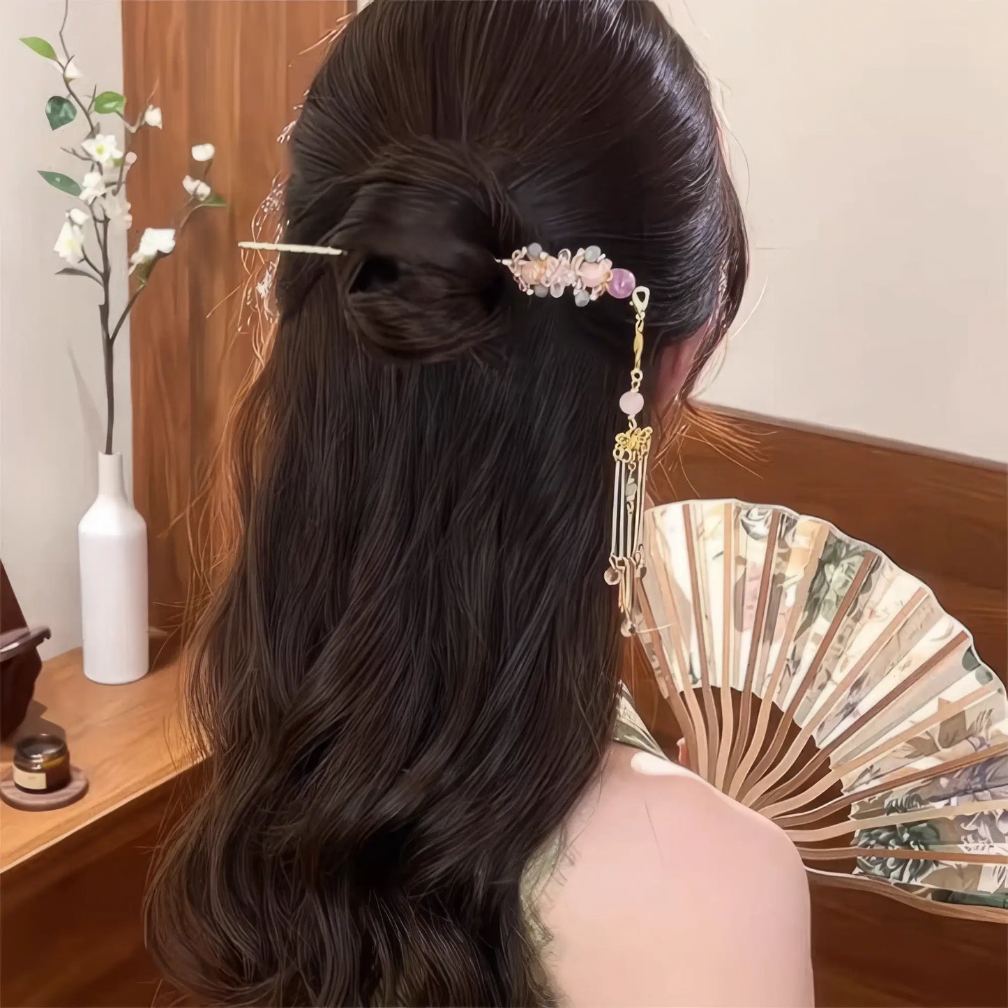 Purple beaded hairpin worn in side hairstyle, tassel swinging detail