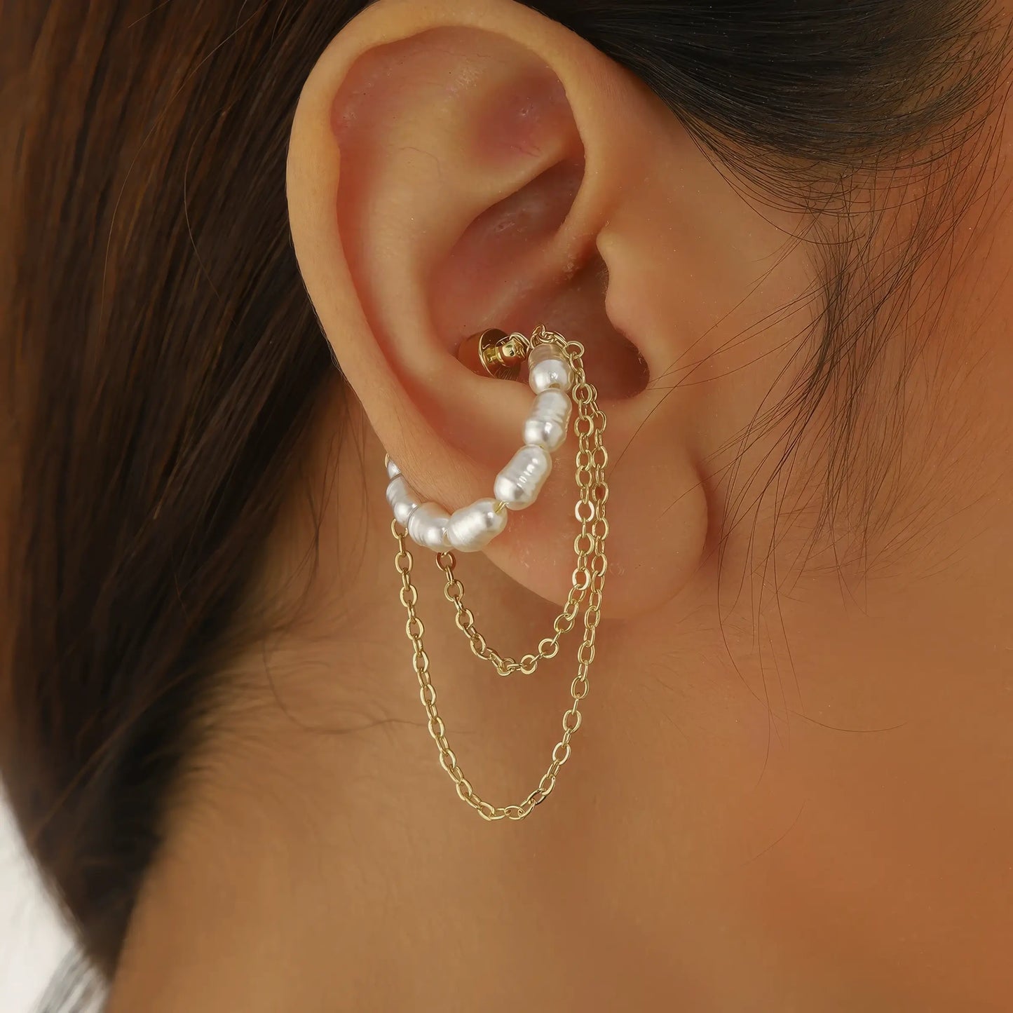 Magnetic pearl tassel ear cuff with pearl chain worn on ear, showcasing elegance