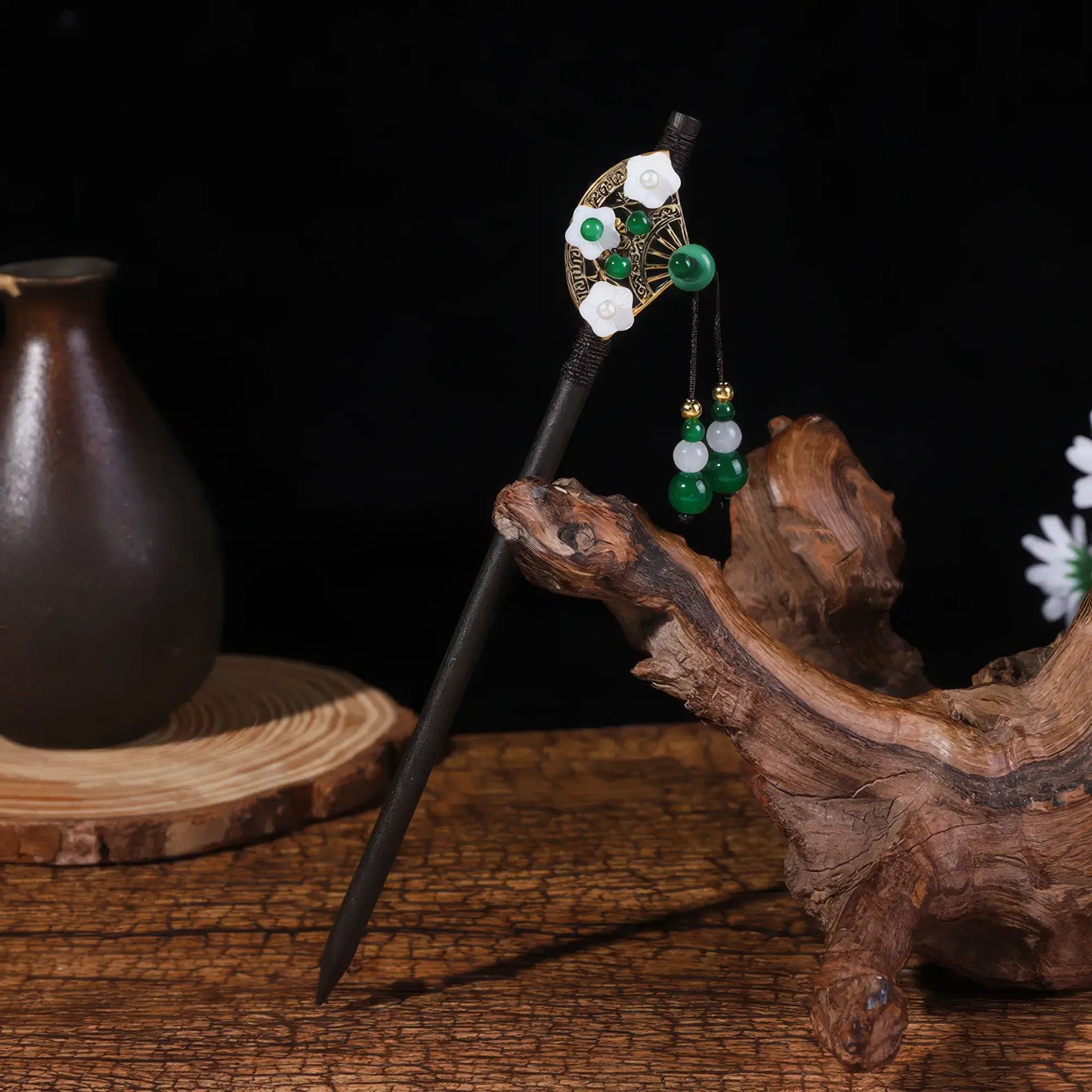 May Lotus hairpin 5 with flower and tassel design, dark background with antique ornaments and white flowers