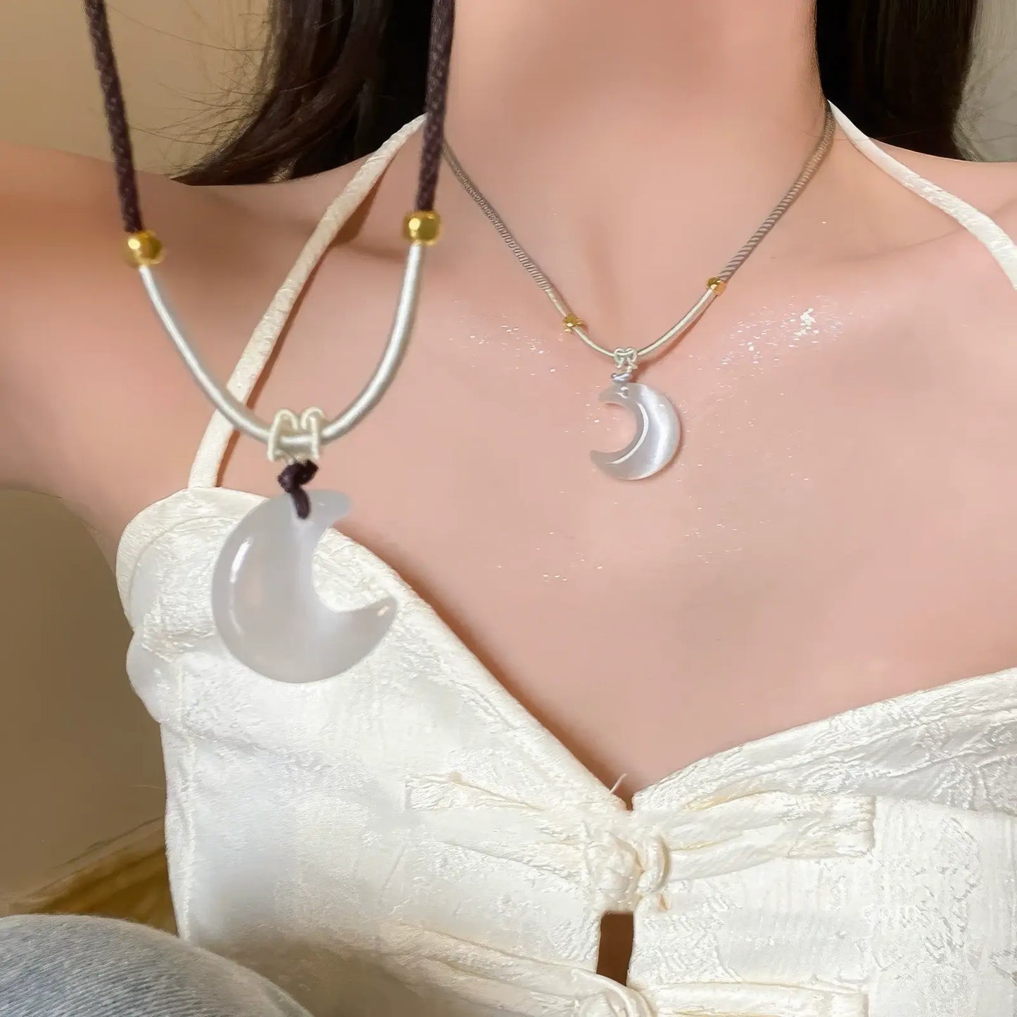 New Chinese style cat's eye moon pendants worn together, showcasing a layered look