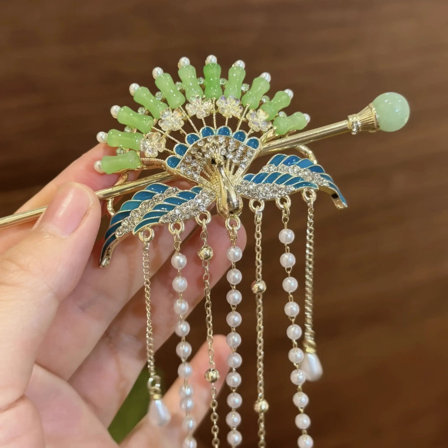 Extreme closeup of new Chinese peacock hairpin’s head design and tassel details