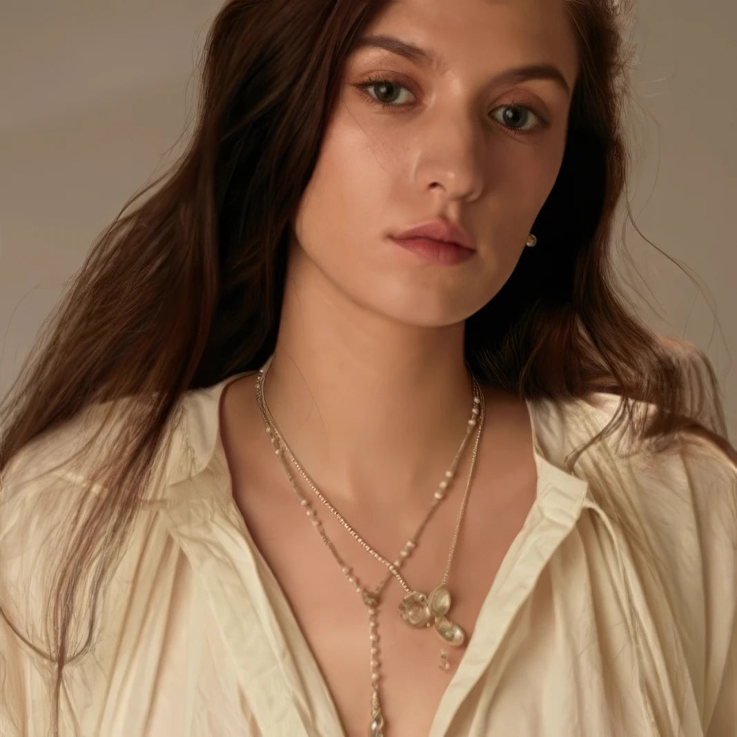 Model wearing layered pearl shell pendant necklaces, highlighting fashion sense