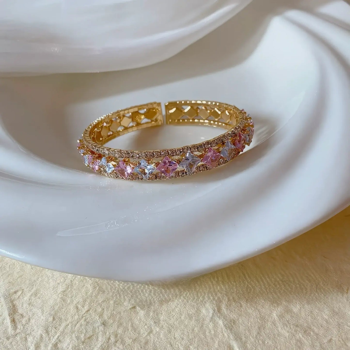 Pink zircon bracelet placed on white plate, emphasizing design