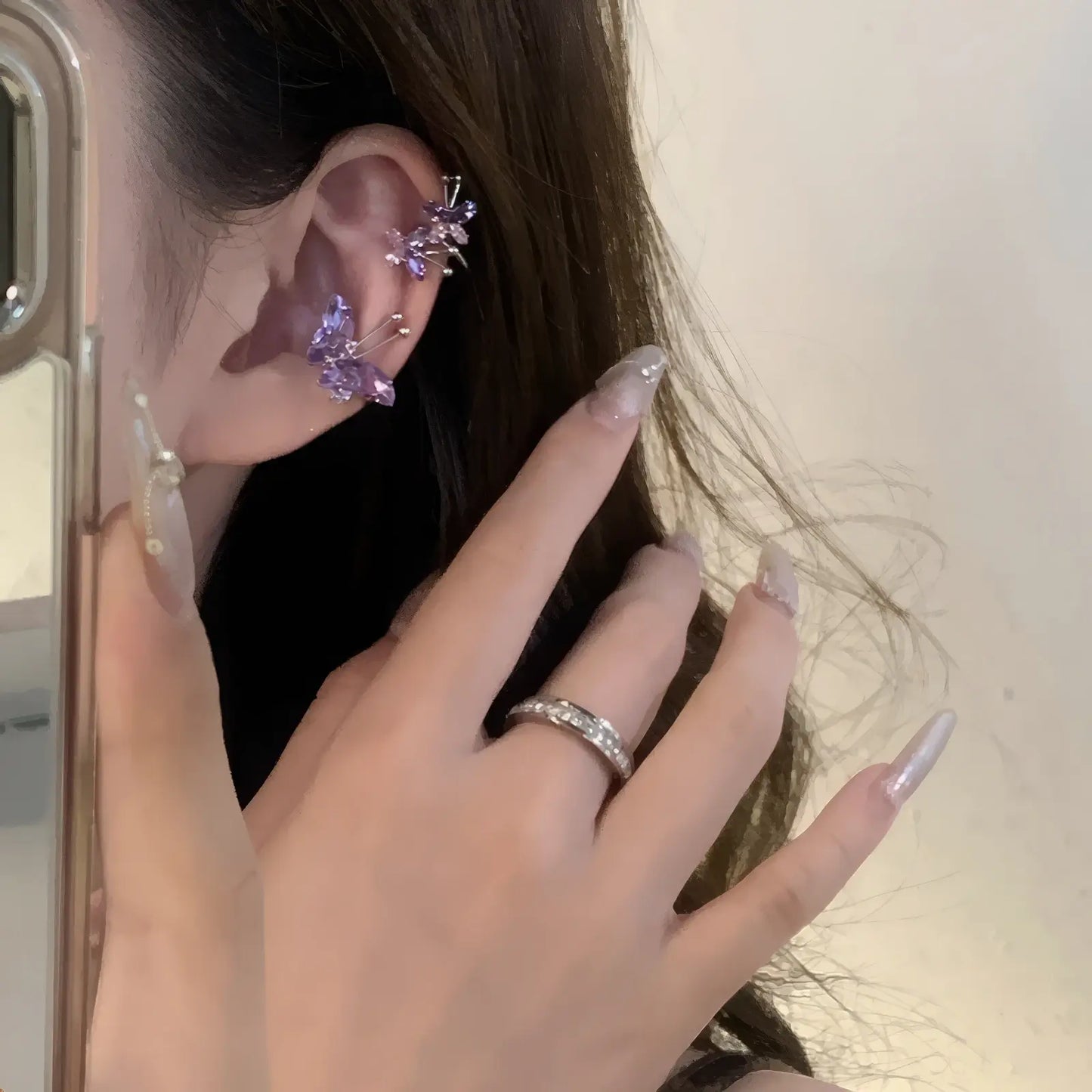 Purple butterfly zircon ear cuff, being adjusted on ear, with ring detail