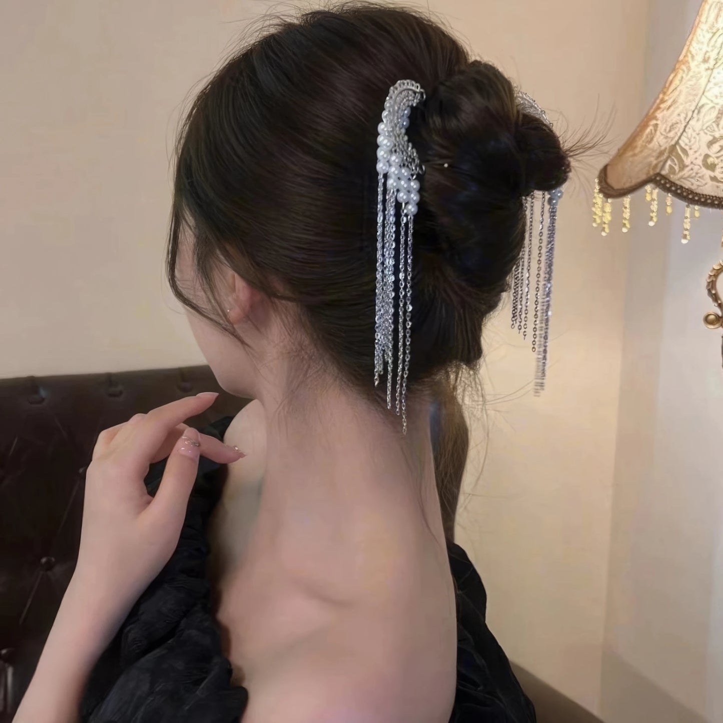 Single beaded tassel U-hairpin worn in updo, side profile with swinging fringe