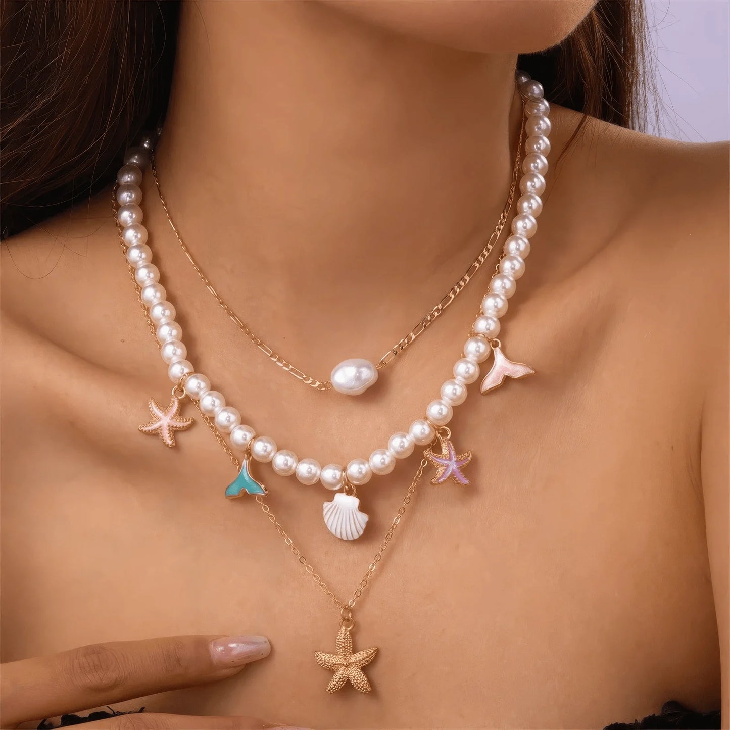 Starfish pearl necklace 3 - piece set worn with bare shoulders, highlighting design