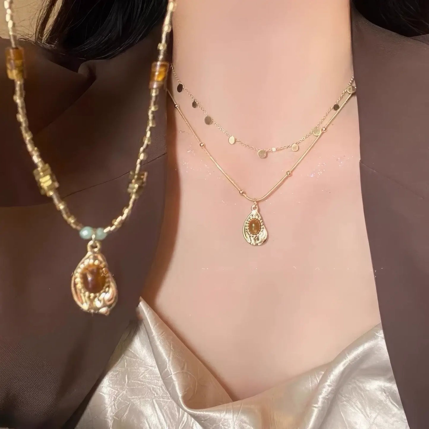 Tiger eye stone beaded layered pendant necklace worn, paired with a brown blazer and satin top, showcasing a fashionable look