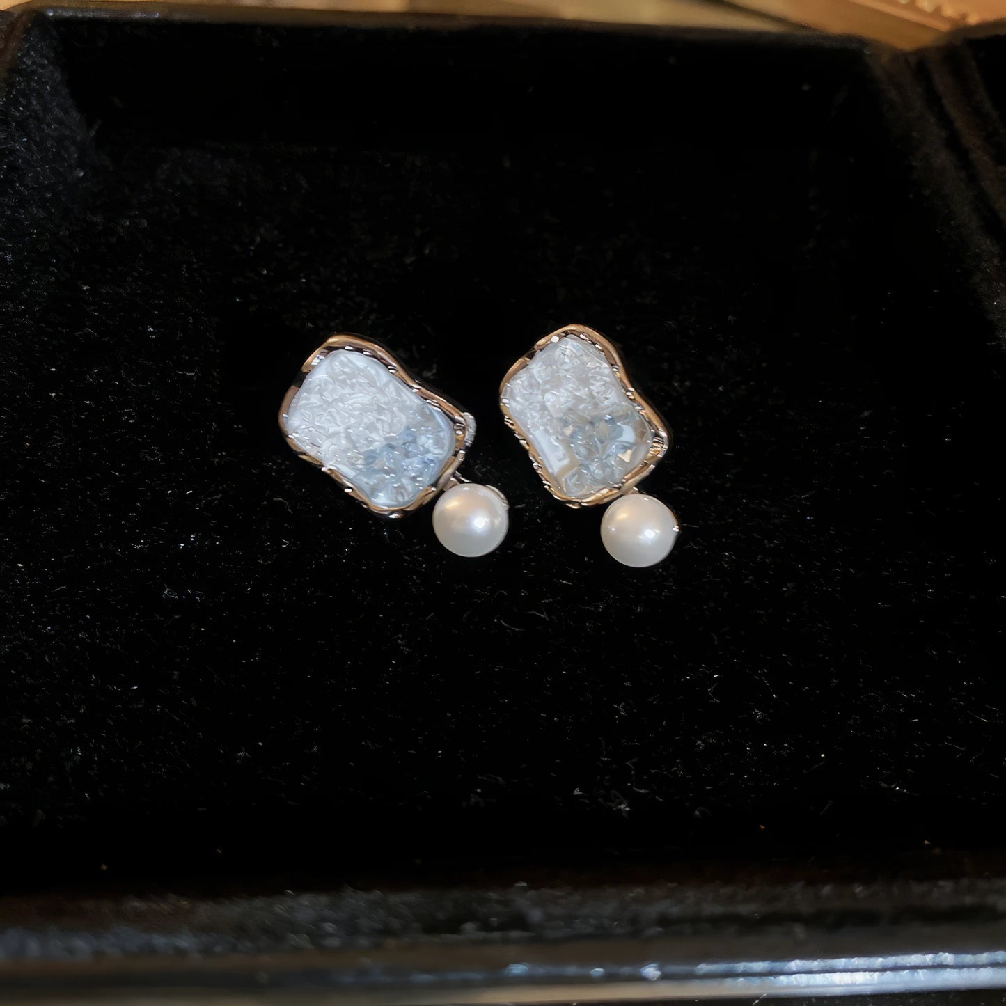 White crystal butterfly earrings on a black background