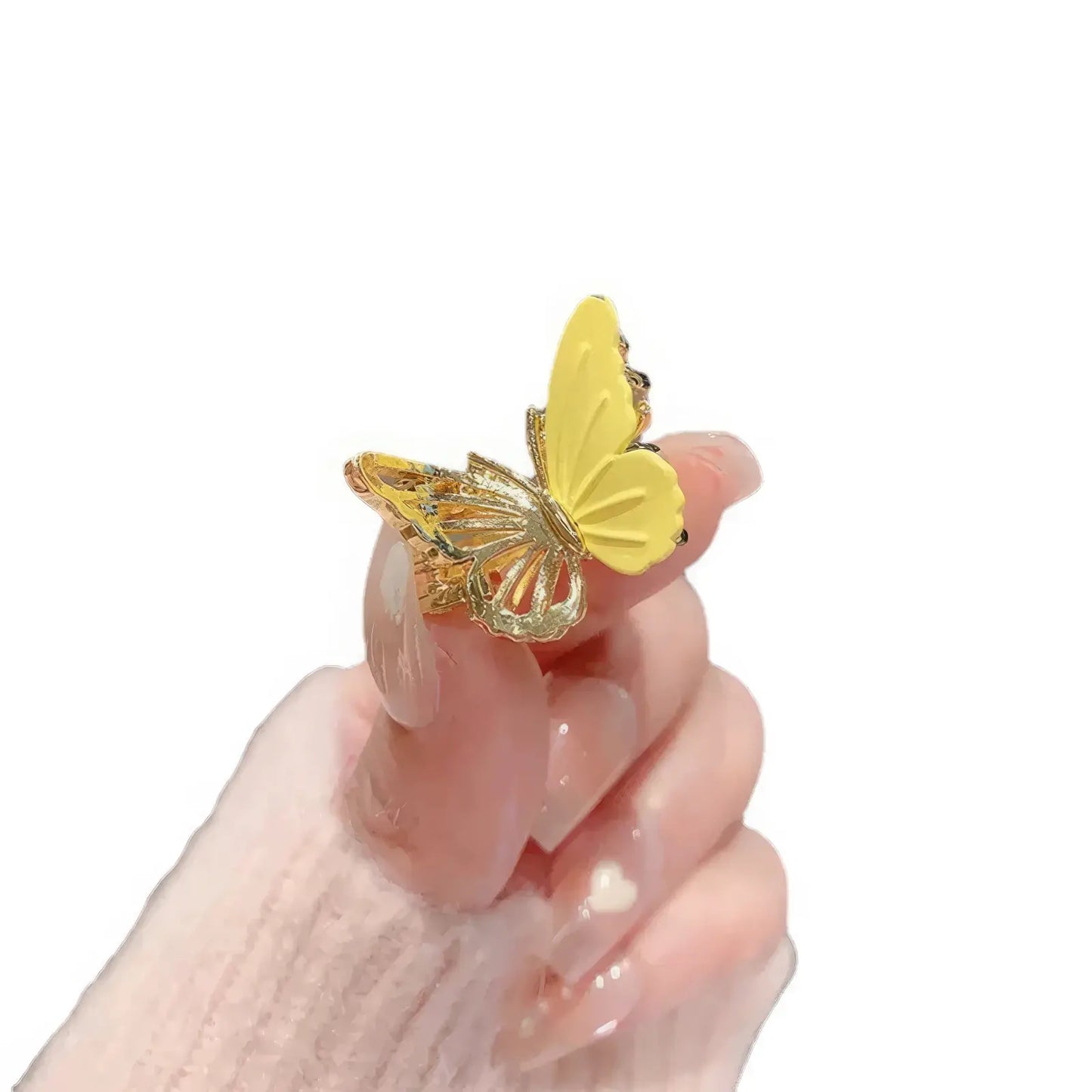 Yellow butterfly mini claw clip on white background, held by hand