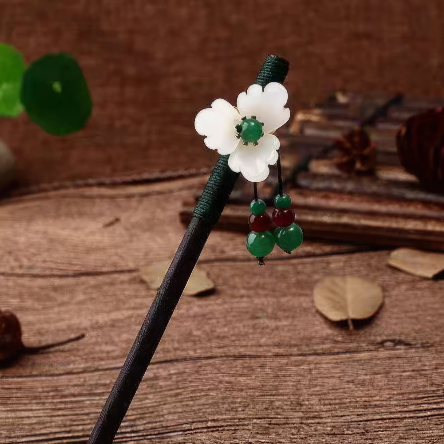 Youqing hairpin with white flower and green beads, brown background with wooden elements