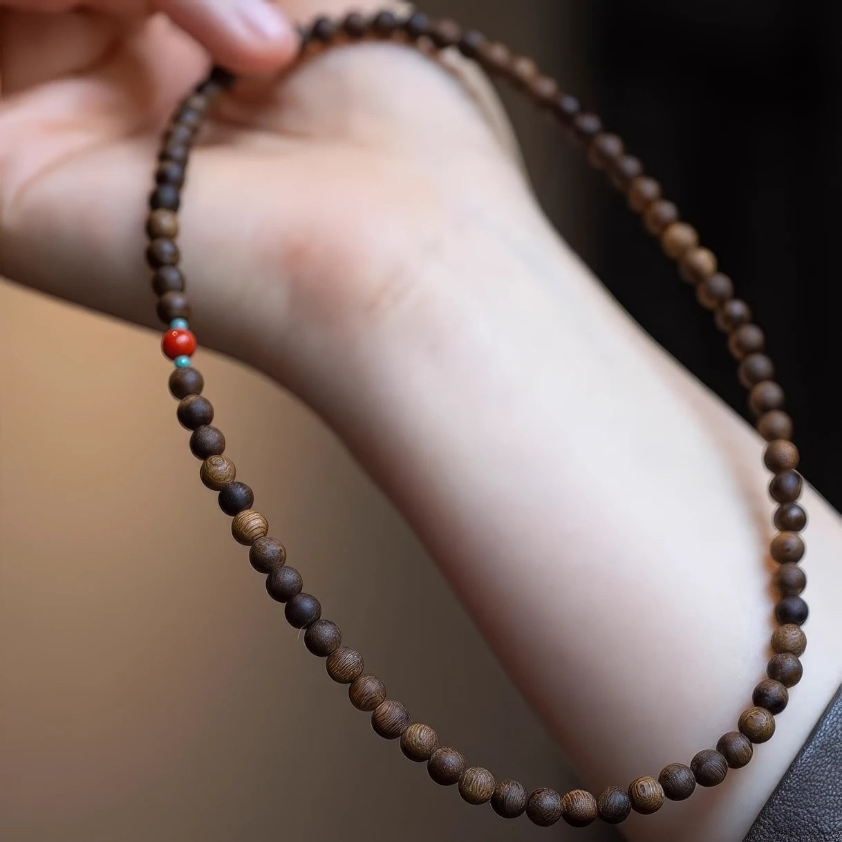  Agarwood double - layer bracelet held in hands, showcasing the length and bead arrangement.