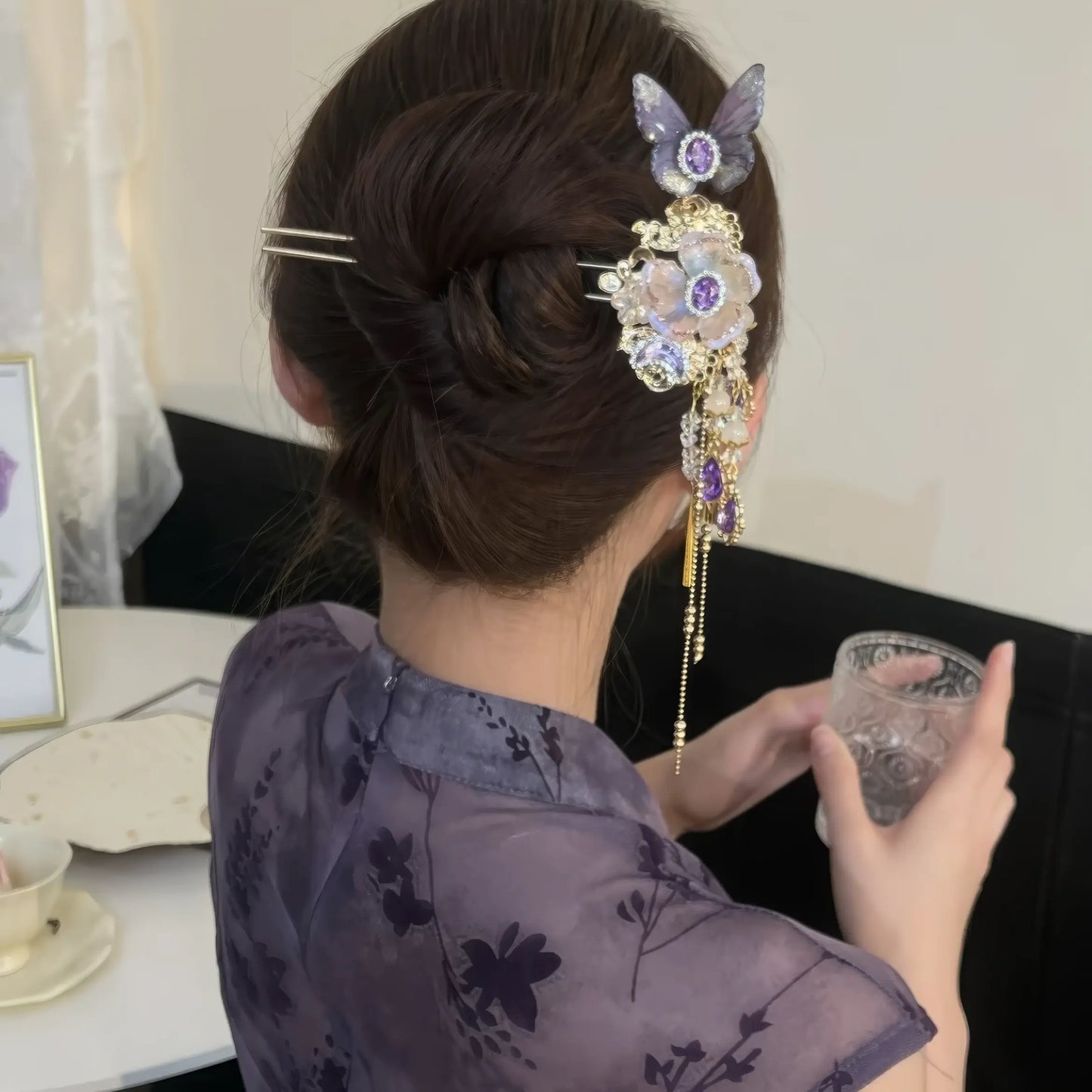 Purple butterfly floral tassel hairpin fixed into a tidy hair bun, long tassels falling down alongside the wearer’s nape.