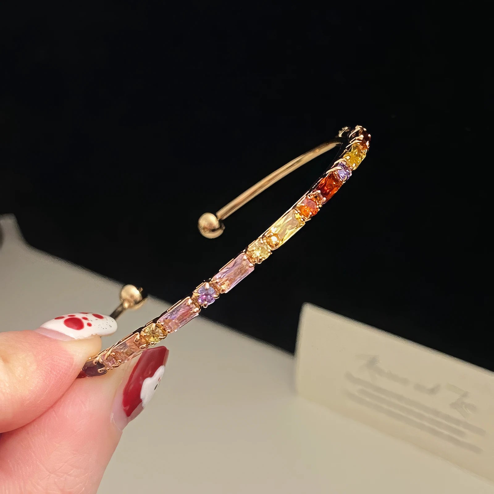 Close - up of a colorful zircon twisted bracelet, showing detailed twisted and zircon elements.