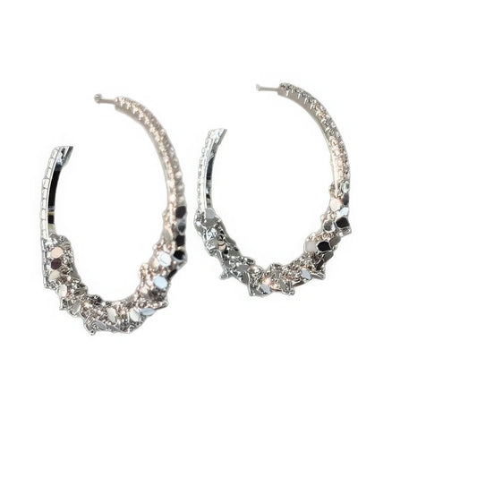 Pair of diamond - inlaid round hoop earrings, isolated on white background, emphasizing the sparkling stone - encrusted design