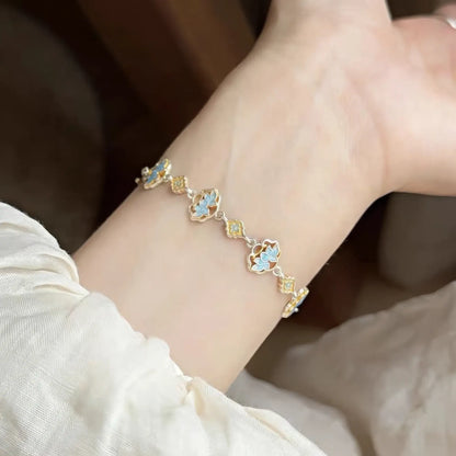 Enamel lotus bracelet worn on wrist, showcasing blue and gold details.