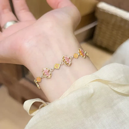 Enamel lotus bracelet worn on wrist, highlighting colorful lotus design.