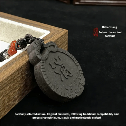 Exorcism Charm incense pendant placed beside a wooden box, with text explaining the careful selection of natural fragrant materials, following traditional compatibility and processing techniques, and slow, meticulous crafting.