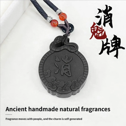 Exorcism Charm incense pendant with Chinese characters "消魁牌" and English text "Ancient handmade natural fragrances, Fragrance moves with people, and the charm is self - generated", attached to a black cord with red beads.
