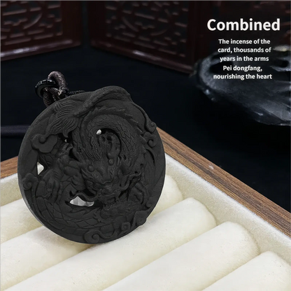 Flying Dragon incense pendant displayed with text "Combined: The incense of the card, thousands of years in the arms. Pei dongfang, nourishing the heart", placed in a box with white lining, emphasizing the pendant's details and traditional craftsmanship.