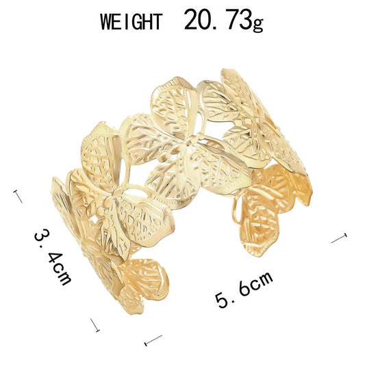 Gold - toned leaf - shaped metal cuff bracelet, with size and weight details.
