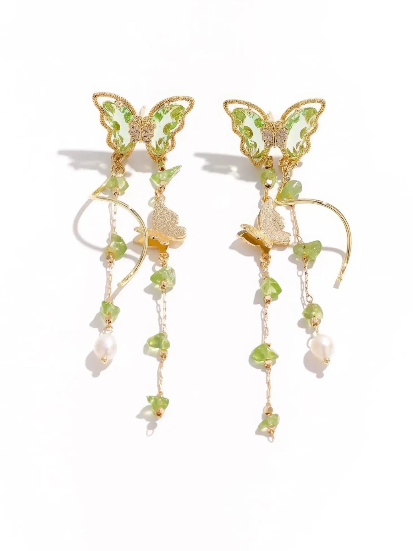 Isolated view of Green Wild Tea Butterfly Tassel Earrings against a plain background, emphasizing their intricate details.