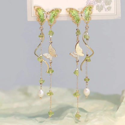 Green Wild Tea Butterfly Tassel Earrings displayed on a card, with a soft, nature - inspired background.
