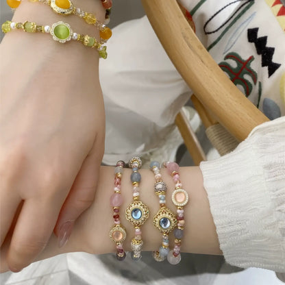 Multiple handmade beaded bracelets stacked on a wrist
