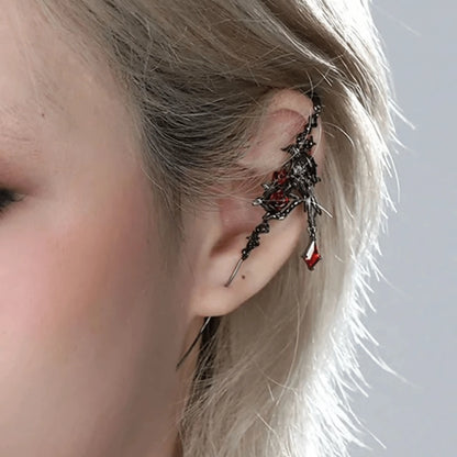 Impression crow ear cuff worn on ear, highlighting the intricate crow and metalwork design.