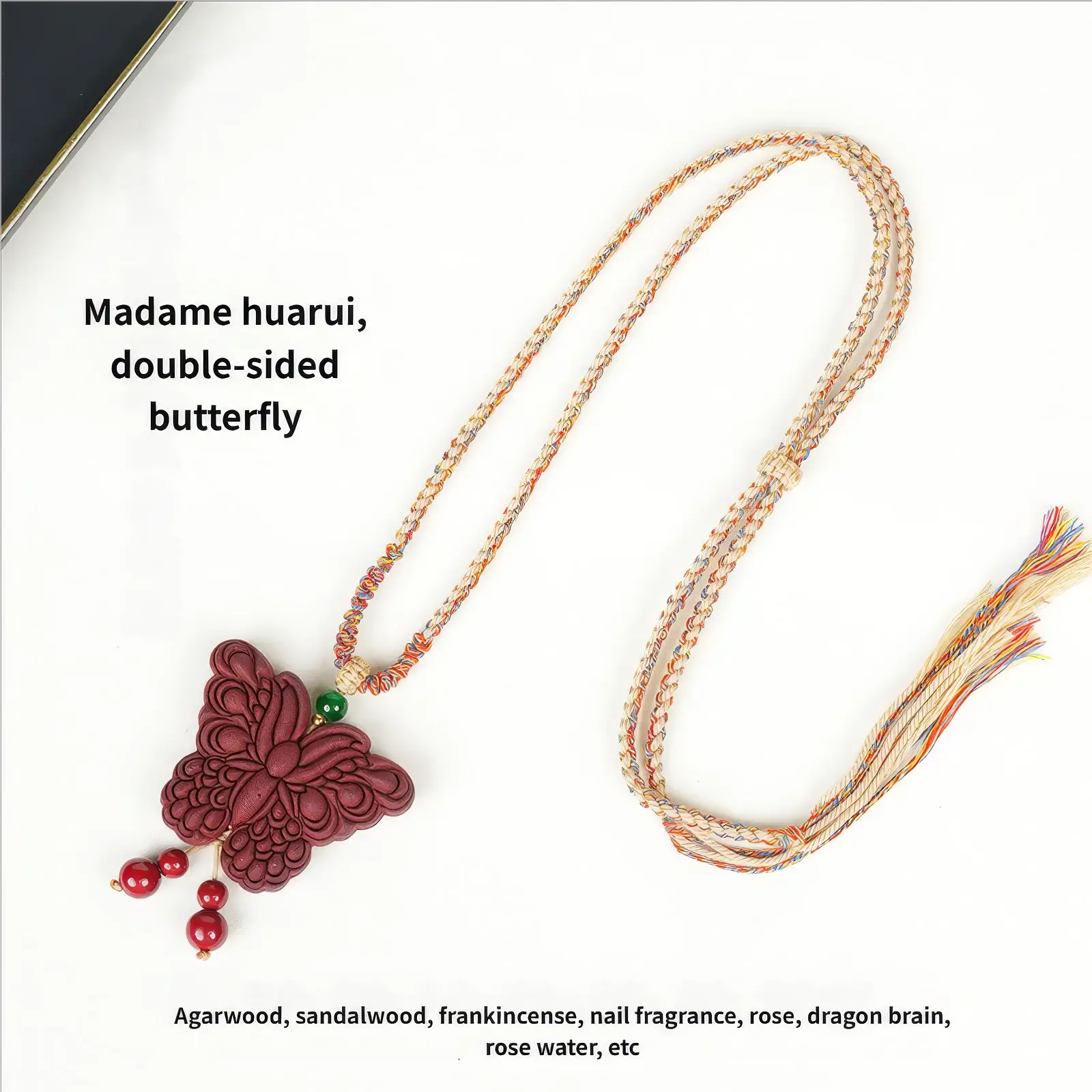 Detail view of the colorful woven cord of the Lady Huarui - Double-Sided Butterfly Incense Pendant, showing the texture and the frayed end of the cord.
