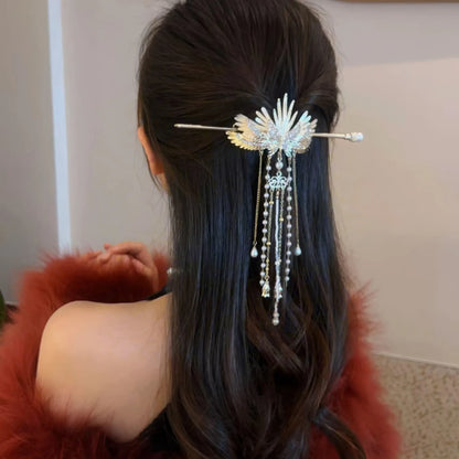Back view of long wavy hair half-fixed by angel wing hairpin, red fur outfit highlighting the hair accessory's elegant sparkling details.