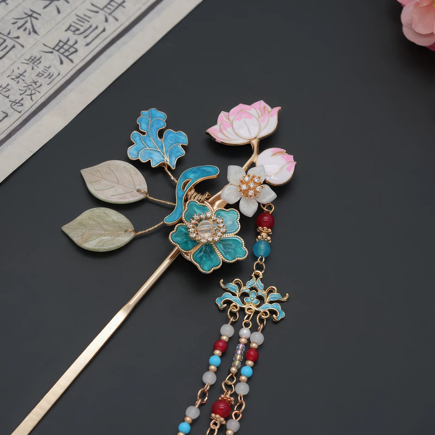 Flat lay shot of the lotus and jade leaf tassel hairpin, showcas