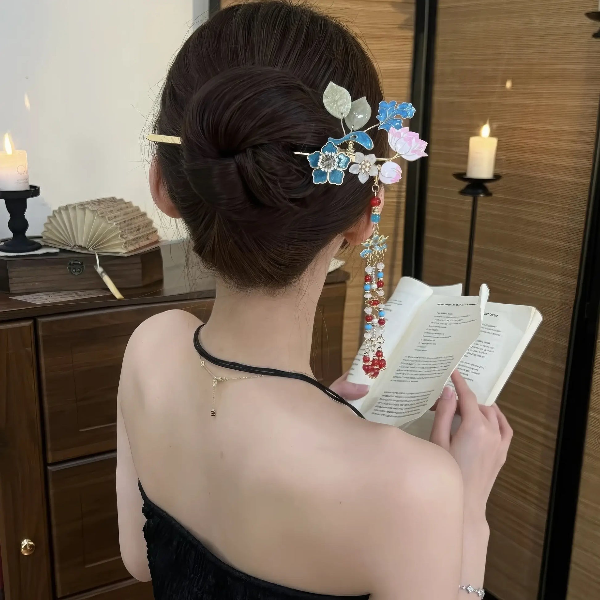 Hairpin worn in a neat bun, with the tassel hanging down the wearer’s back as she holds a book, demonstrating the elegant drape of the beads.