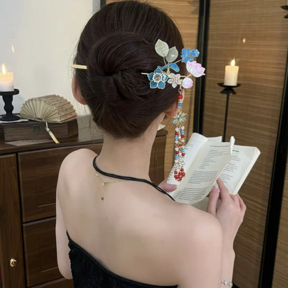 Hairpin worn in a neat bun, with the tassel hanging down the wearer’s back as she holds a book, demonstrating the elegant drape of the beads.