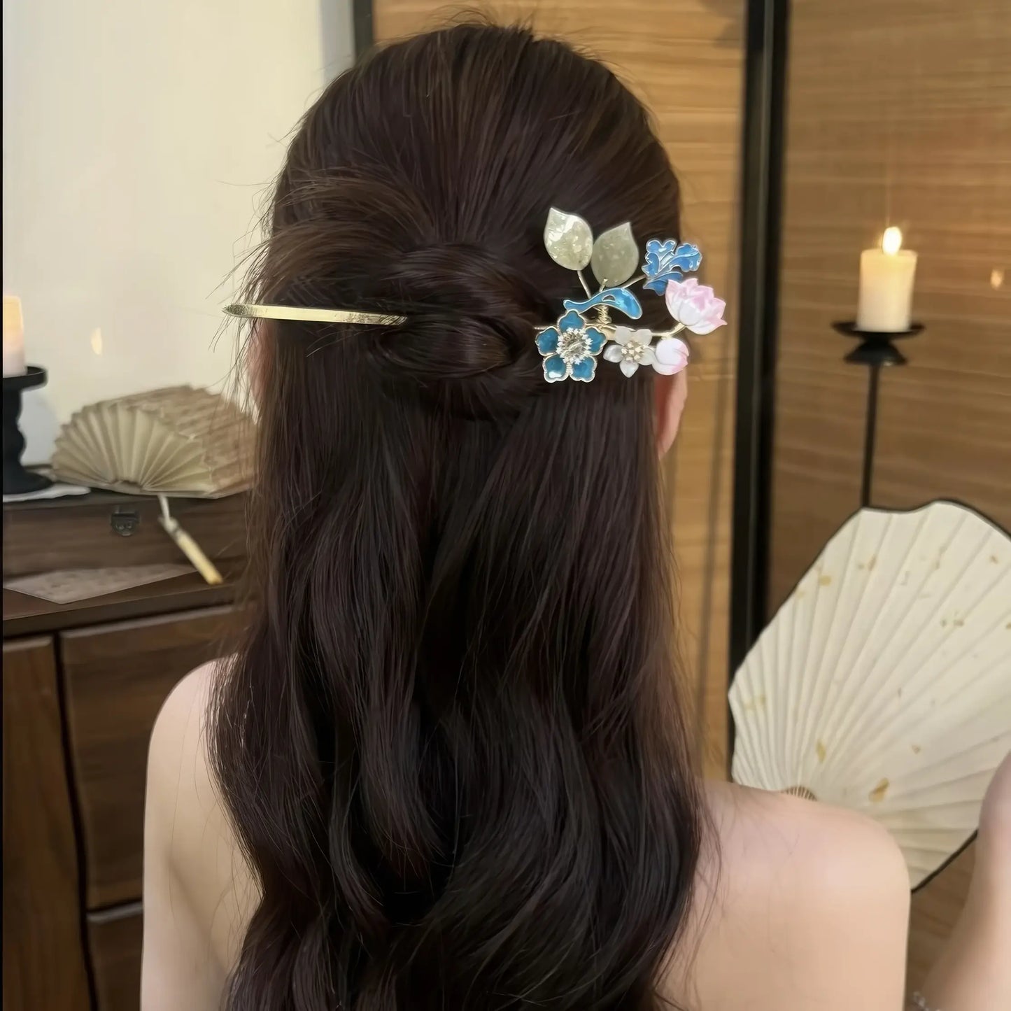Hairpin worn in a half-up hairstyle, showing how the floral top sits in the hair with the tassel hanging down the back.