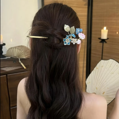 Hairpin worn in a half-up hairstyle, showing how the floral top sits in the hair with the tassel hanging down the back.