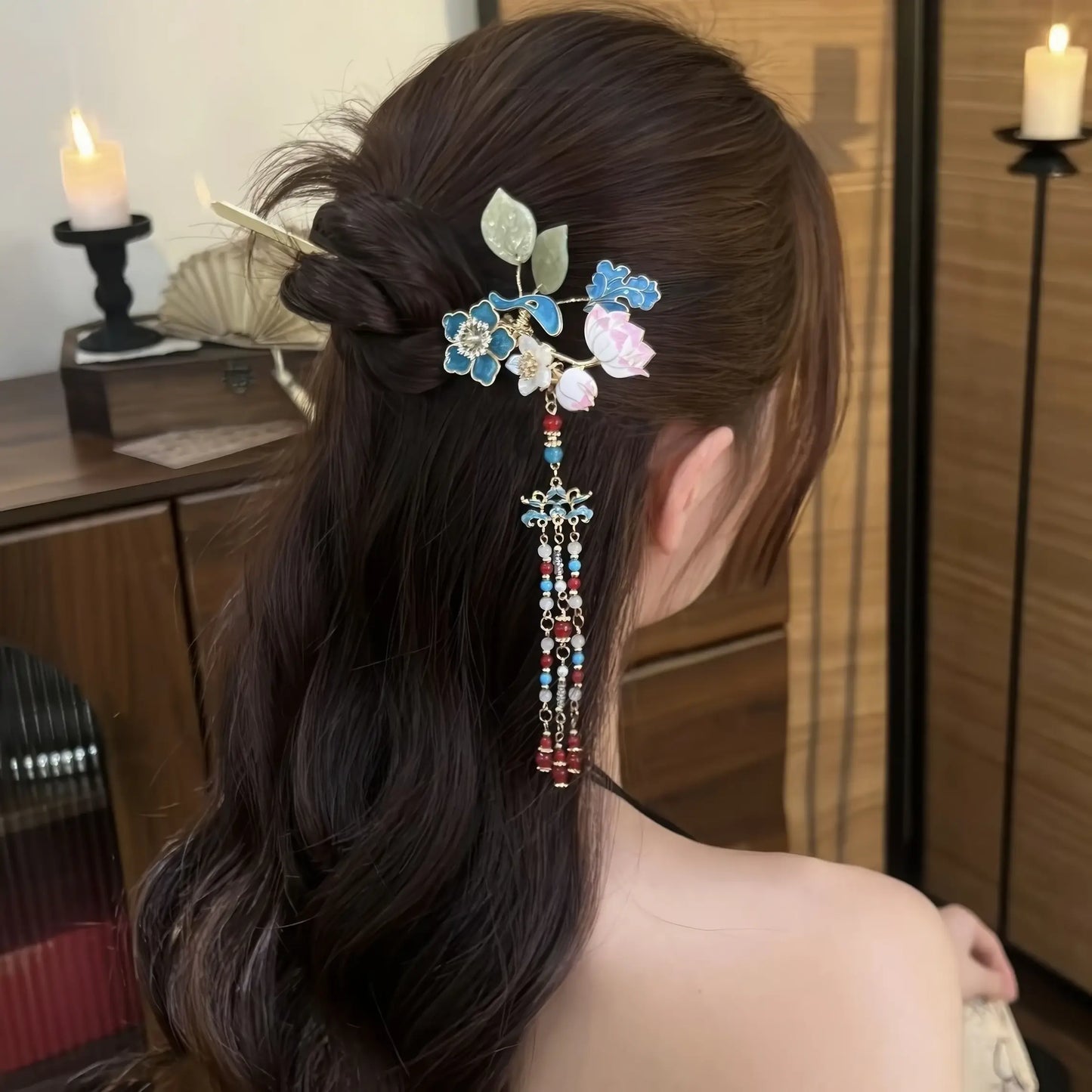 Side profile of the hairpin worn in a low bun, showing the tassel swaying gently against the wearer’s hair and shoulder.